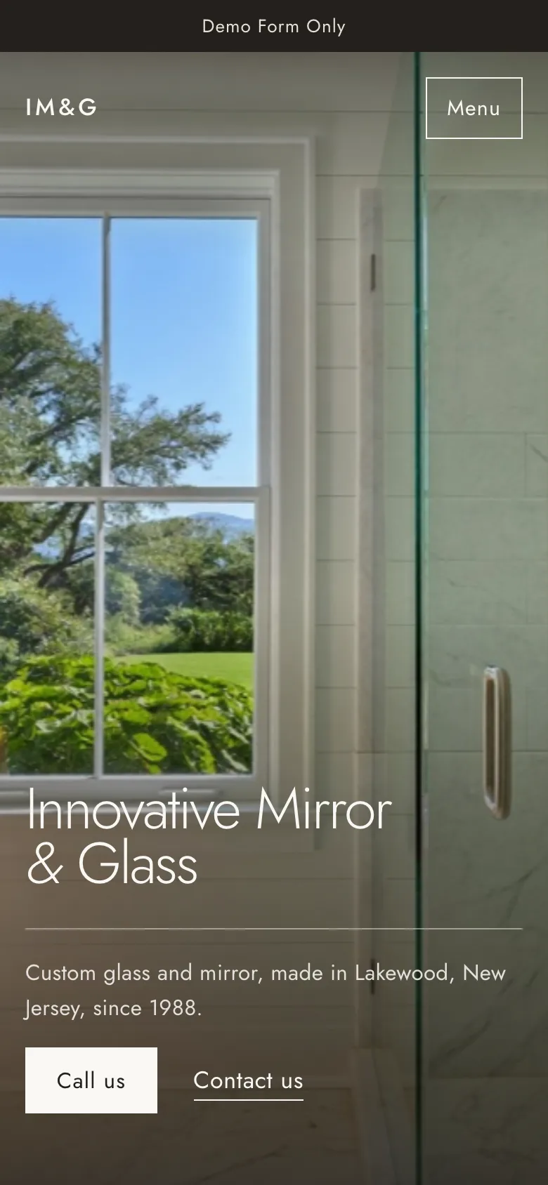 Innovative Mirror & Glass homepage on a phone: the glass shower and window kept in frame, with the name and two contact buttons below.